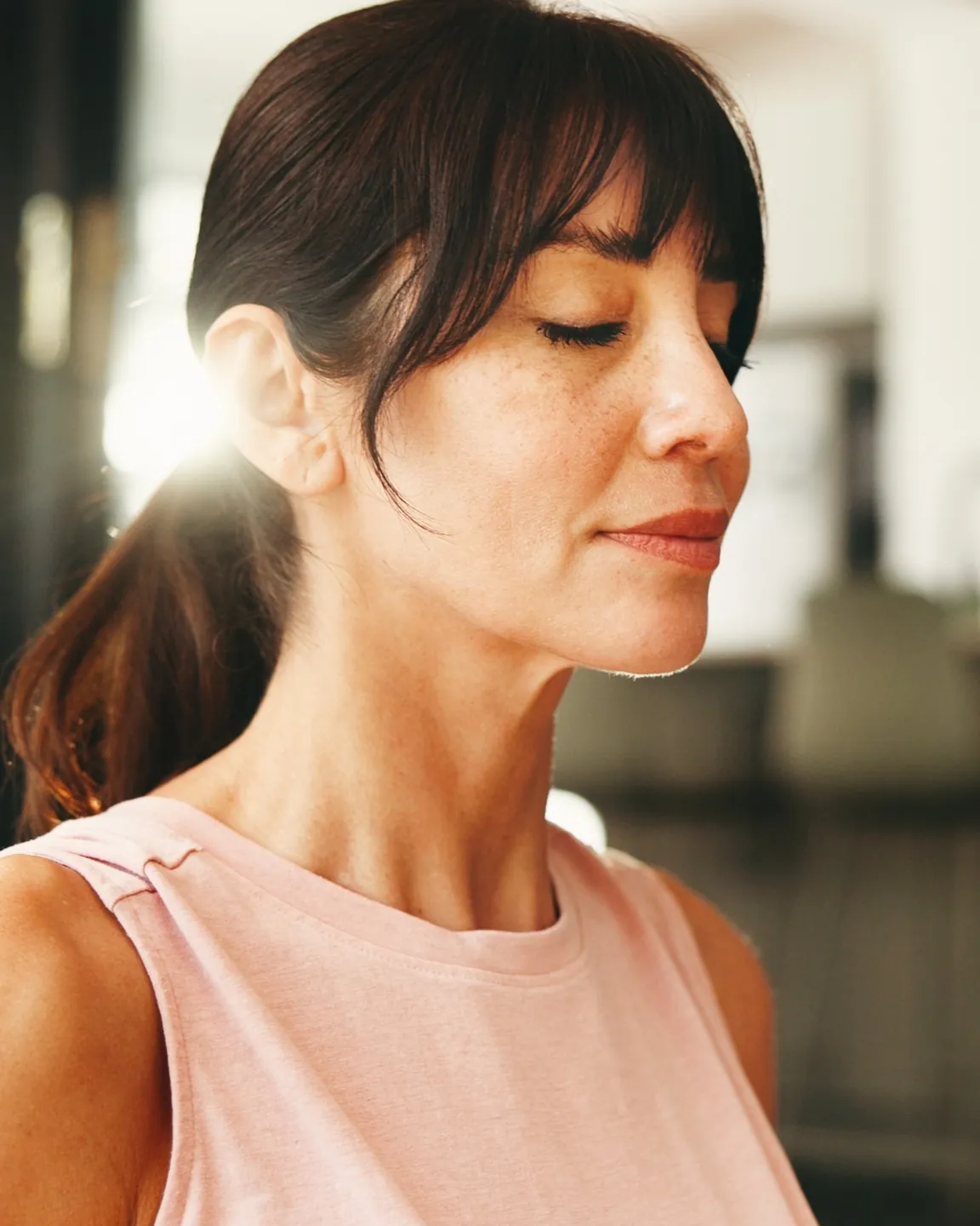 A woman with her eyes closed, calm and at ease
